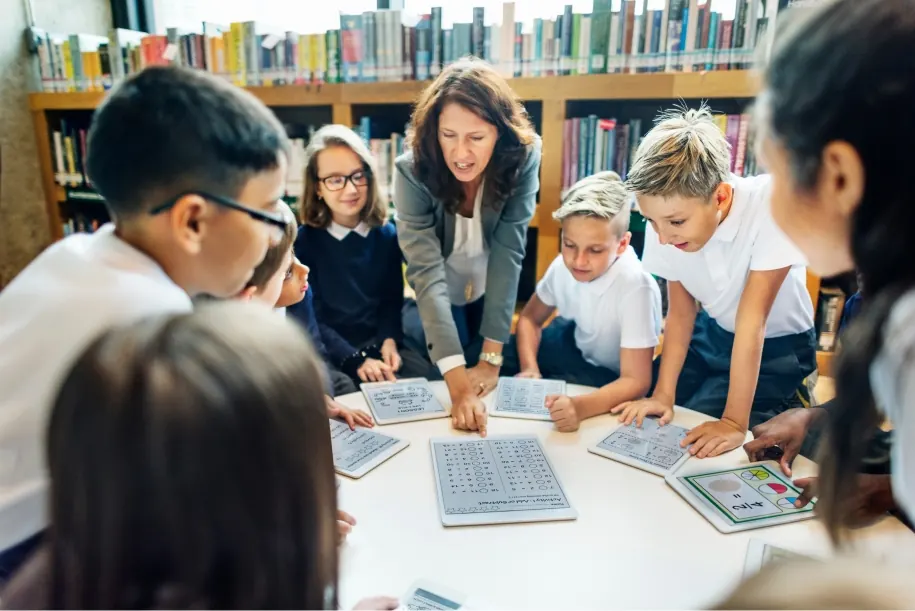 Teacher guiding students in a library classroom